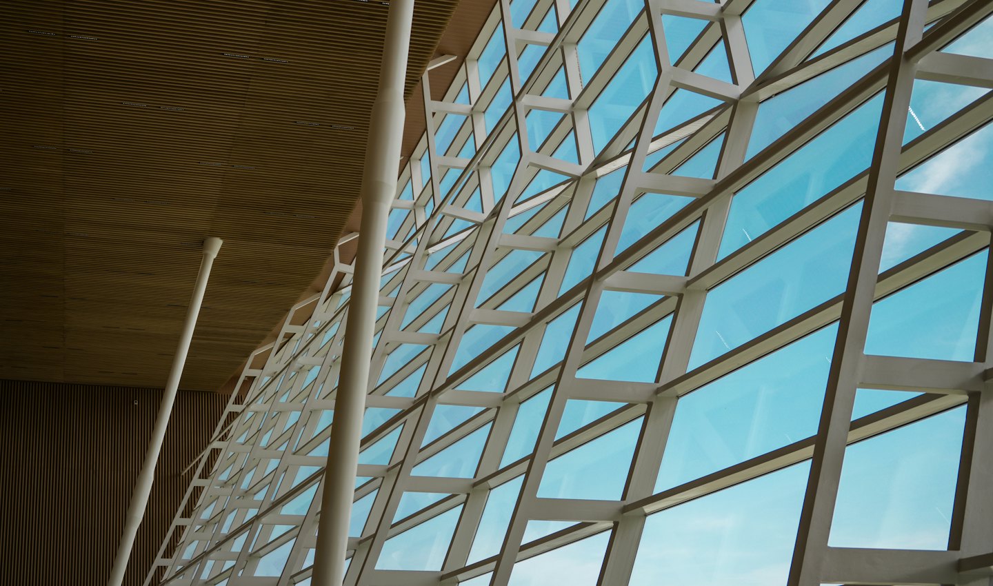 Modern building interior with geometric windows looking at the sky.