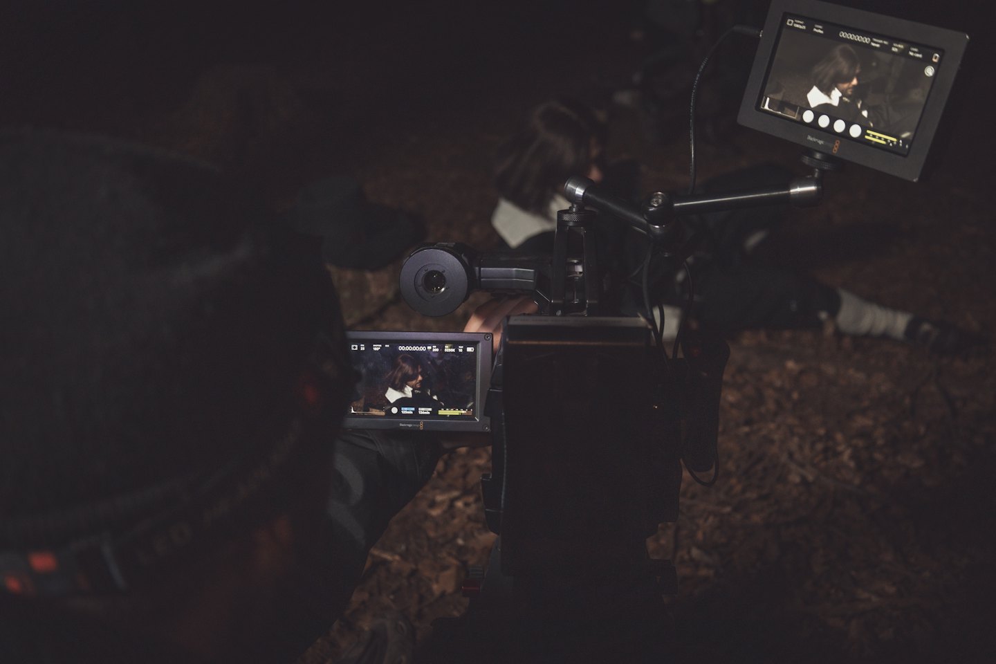 Videographer monitors footage on dual Blackmagic monitors.