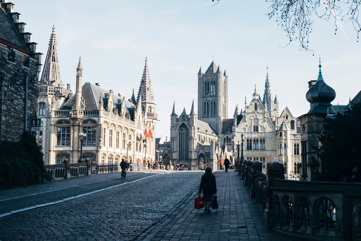 Historic European city street with cobblestones and shops.